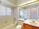 Bright bathroom with tub and a single sink vanity with wood cabinets at 148 Meadow Blvd, Sanford, FL 32771