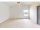Spacious bedroom with a large window, offering natural light and a serene view of the water at 148 Meadow Blvd, Sanford, FL 32771