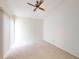 Bright bedroom with neutral carpet, ceiling fan, and large windows for natural light at 148 Meadow Blvd, Sanford, FL 32771