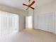 Spacious bedroom with ceiling fan, closet, and sliding door to the outside at 148 Meadow Blvd, Sanford, FL 32771
