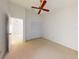 Light bedroom with ceiling fan and closet with beige carpet flooring at 148 Meadow Blvd, Sanford, FL 32771