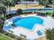 Overhead view of a community pool, perfect for relaxation, surrounded by lounge chairs and greenery at 148 Meadow Blvd, Sanford, FL 32771