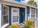 Inviting front entrance featuring a glass storm door, wreath, and trimmed bushes at 148 Meadow Blvd, Sanford, FL 32771