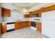 Functional kitchen with oak cabinets, white appliances, and a clean layout, ideal for everyday meals at 148 Meadow Blvd, Sanford, FL 32771