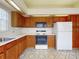 Efficient kitchen featuring wood cabinets, white countertops, and essential appliances, perfect for home cooking at 148 Meadow Blvd, Sanford, FL 32771