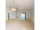 Spacious living room with plush carpeting, ceiling fan, and sliding glass doors to the lanai at 148 Meadow Blvd, Sanford, FL 32771
