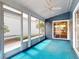 Inviting sunroom with ample light, ceiling fan, and access to the yard at 148 Meadow Blvd, Sanford, FL 32771