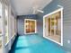 Covered outdoor patio providing a relaxing space with bright blue carpet at 148 Meadow Blvd, Sanford, FL 32771