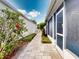 Charming side walkway leading to the backyard with manicured landscaping at 148 Meadow Blvd, Sanford, FL 32771