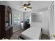 This bedroom has a desk area, ceiling fan, and a built in Murphy bed pulled down into a bed at 1527 Braewick St, Winter Springs, FL 32708