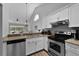 An open kitchen design with stainless steel appliances and a breakfast bar overlooking the backyard at 1527 Braewick St, Winter Springs, FL 32708