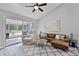 Cozy living room with modern gray floors, ceiling fan, comfortable seating, and bright, natural light at 1527 Braewick St, Winter Springs, FL 32708