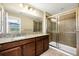 Bathroom features a vanity with granite countertops and a modern glass shower at 15366 Sandfield Loop, Winter Garden, FL 34787