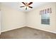 Bright bedroom featuring a ceiling fan, window, and neutral walls at 15366 Sandfield Loop, Winter Garden, FL 34787