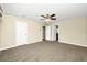 Spacious bedroom with carpet, ceiling fan, neutral walls, and two doors at 15366 Sandfield Loop, Winter Garden, FL 34787