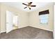 Bedroom with a ceiling fan, plush carpeting, and a sunlit window at 15366 Sandfield Loop, Winter Garden, FL 34787