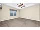 Bedroom with neutral walls, carpeted floor, ceiling fan, and a bright window at 15366 Sandfield Loop, Winter Garden, FL 34787