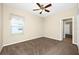 Bedroom features neutral walls, brown carpet, and a ceiling fan for added comfort at 15366 Sandfield Loop, Winter Garden, FL 34787