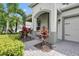 Inviting front porch with stone walkway, arched entryway, and decorative landscaping at 15366 Sandfield Loop, Winter Garden, FL 34787