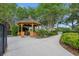 Community gazebo with seating nestled among mature trees and lush greenery at 15366 Sandfield Loop, Winter Garden, FL 34787