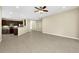 Spacious living room featuring tile floors, neutral walls, ceiling fan, and open kitchen area at 15366 Sandfield Loop, Winter Garden, FL 34787