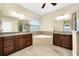 Luxurious main bathroom with dual vanities, jetted tub, and walk-in shower at 15366 Sandfield Loop, Winter Garden, FL 34787