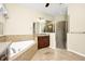 Main bathroom featuring a soaking tub and a separate glass enclosed shower at 15366 Sandfield Loop, Winter Garden, FL 34787