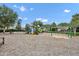 Community playground featuring swings, slides, and climbing structures on a wood chip surface at 15366 Sandfield Loop, Winter Garden, FL 34787