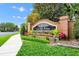 Elegant community sign at 'The Reserve at Carriage Pointe' with brick accents and vibrant landscaping at 15366 Sandfield Loop, Winter Garden, FL 34787