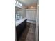A bathroom with dark cabinets, neutral countertops, a sink, decorative accents, and a shower/tub at 1540 Fleur Dr, Davenport, FL 33837
