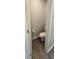 This compact bathroom features sleek wood floors, a toilet, and a fresh coat of neutral paint at 1540 Fleur Dr, Davenport, FL 33837