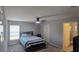 A bedroom with a dark bed frame, a window, and a ceiling fan offers comfort and style at 1540 Fleur Dr, Davenport, FL 33837