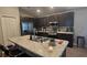 Well-equipped kitchen featuring stainless steel appliances, modern cabinets, and a spacious granite island at 1540 Fleur Dr, Davenport, FL 33837