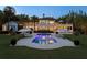 Gorgeous backyard featuring a pristine pool, lounging area with umbrellas, and exterior view of the luxury home at 1640 E Adams Dr, Maitland, FL 32751