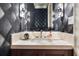 Chic powder room featuring designer wallpaper, elegant lighting, and a modern undermount sink at 1640 E Adams Dr, Maitland, FL 32751