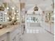 Luxurious bathroom with marble floors, a vaulted ceiling, dual vanities, and a soaking tub at 1640 E Adams Dr, Maitland, FL 32751