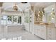 Bright primary bathroom with marble floors, dual vanities, and a large soaking tub with scenic views at 1640 E Adams Dr, Maitland, FL 32751