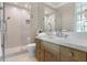 Elegant bathroom with a glass walk-in shower, tiled accent wall, and wooden vanity at 1640 E Adams Dr, Maitland, FL 32751