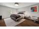 Serene bedroom with a tufted headboard, dark wood floors, ample natural light, and stylish decor at 1640 E Adams Dr, Maitland, FL 32751
