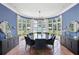 Bright dining room featuring a bay window with pool views, elegant lighting, and terra-cotta flooring at 1640 E Adams Dr, Maitland, FL 32751