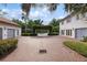 Expansive brick driveway leading to the home, complemented by manicured landscaping and multiple garages at 1640 E Adams Dr, Maitland, FL 32751
