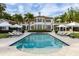 Stunning exterior view featuring a pool, lounge chairs, umbrellas and lush green lawn at 1640 E Adams Dr, Maitland, FL 32751