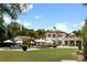 Stunning home exterior with lush green lawn, sparkling pool, umbrellas, and lounge chairs at 1640 E Adams Dr, Maitland, FL 32751