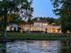 Waterfront estate with well-manicured backyard, pool, outdoor lounging area, and elegant exterior architecture at 1640 E Adams Dr, Maitland, FL 32751