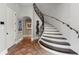 Elegant hallway featuring a curved staircase with iron railings and decorative tile floors at 1640 E Adams Dr, Maitland, FL 32751