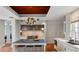 The open kitchen with blue island and stainless steel appliances is perfect for cooking and entertaining at 1640 E Adams Dr, Maitland, FL 32751
