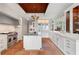 Gourmet kitchen with white cabinets, marble countertops, stainless steel appliances, and a chef's island for meal preparation at 1640 E Adams Dr, Maitland, FL 32751