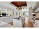 Modern kitchen with white cabinetry, marble countertops, high-end appliances, and an island overlooking a view of the yard at 1640 E Adams Dr, Maitland, FL 32751