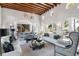 Spacious living room with vaulted wood-beam ceilings, designer lighting, and stylish decor creating a welcoming atmosphere at 1640 E Adams Dr, Maitland, FL 32751