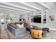 Bright living room featuring neutral colors, beam ceilings, and a built-in entertainment center at 1640 E Adams Dr, Maitland, FL 32751